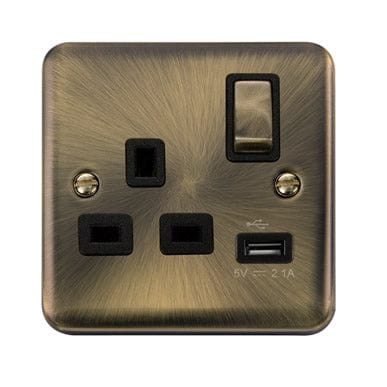 Curved Antique Brass 13A Ingot 1 Gang Switched Plug Socket With 2.1A USB Outlet - Black Trim